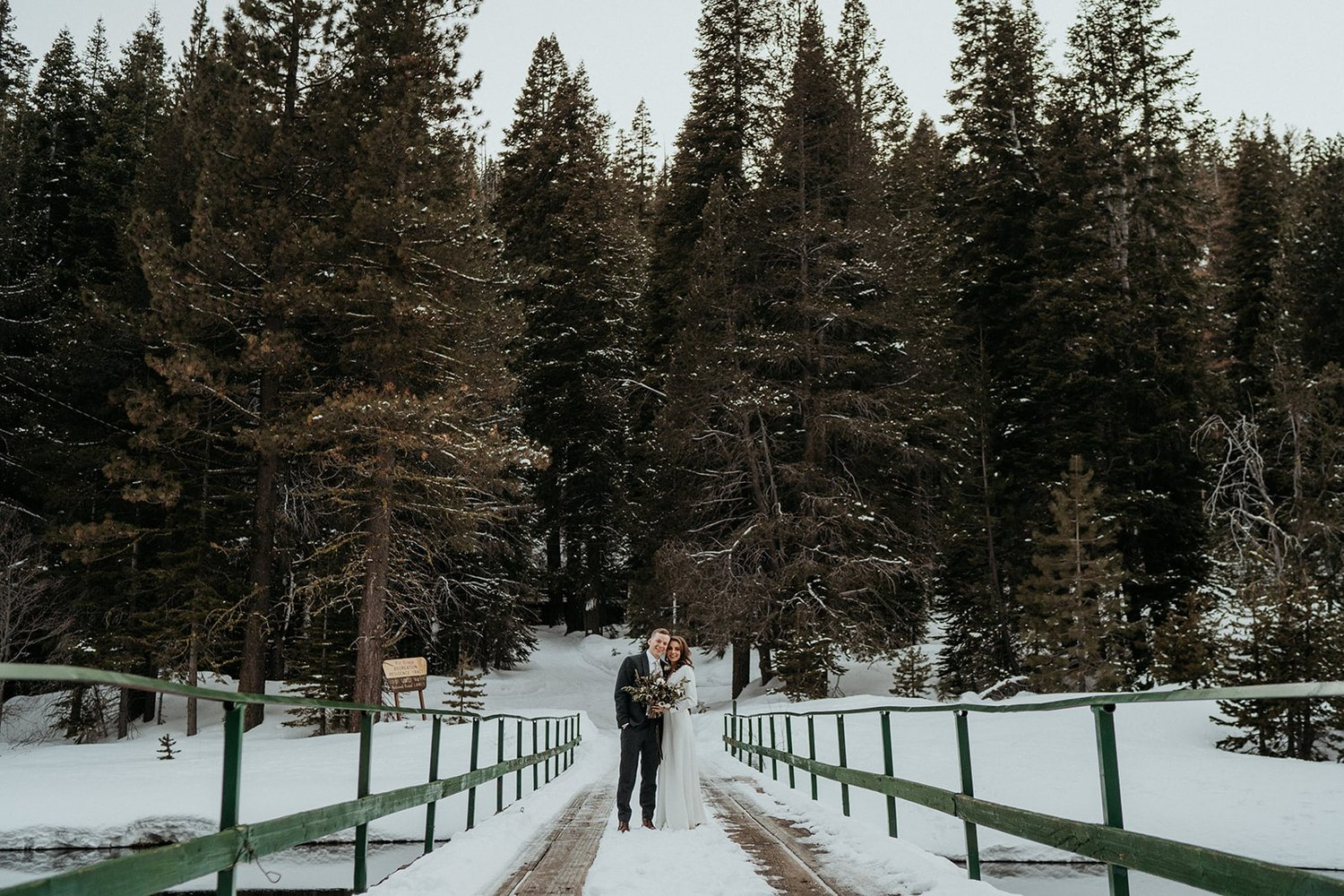 Bride and groom kiss on a snowy bride during their Lake Tahoe elopement in California.