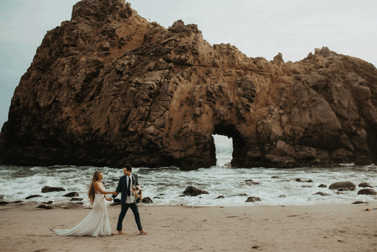 Bride and groom walk across the beach during their Big Sur beach elopement