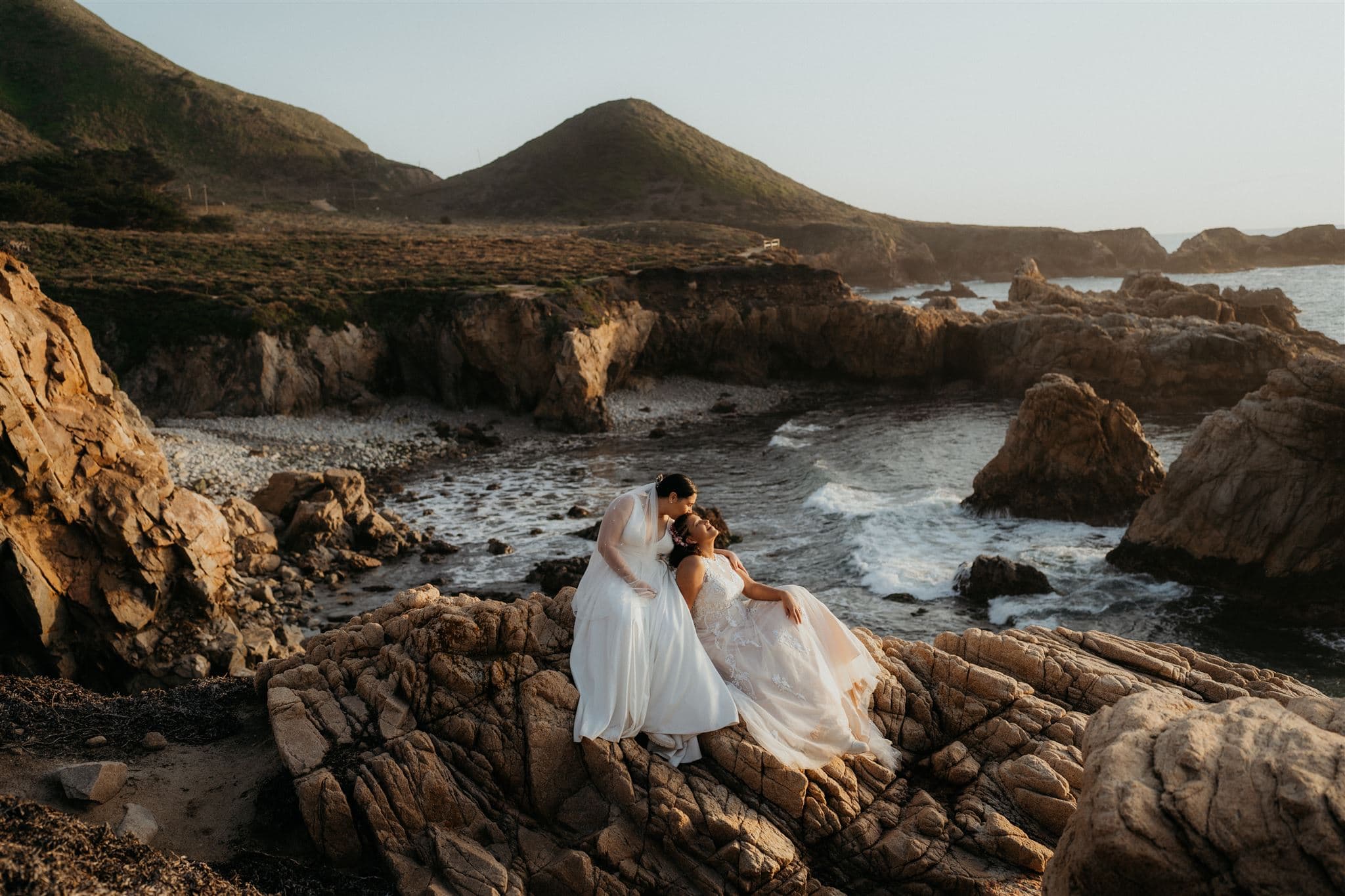Same sex couple eloped in Big Sur on a cliff with rugged rocks.