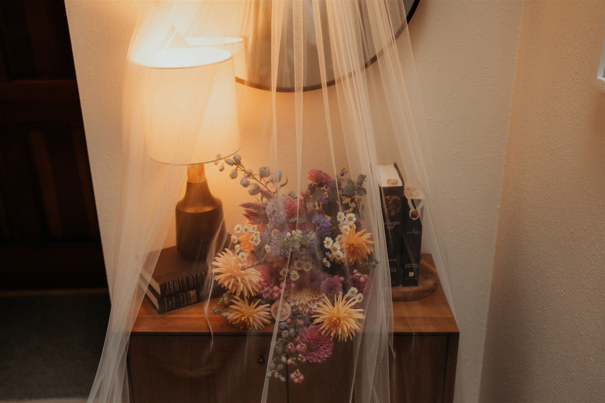 Veil overlaying a lamp and elopement bouquet