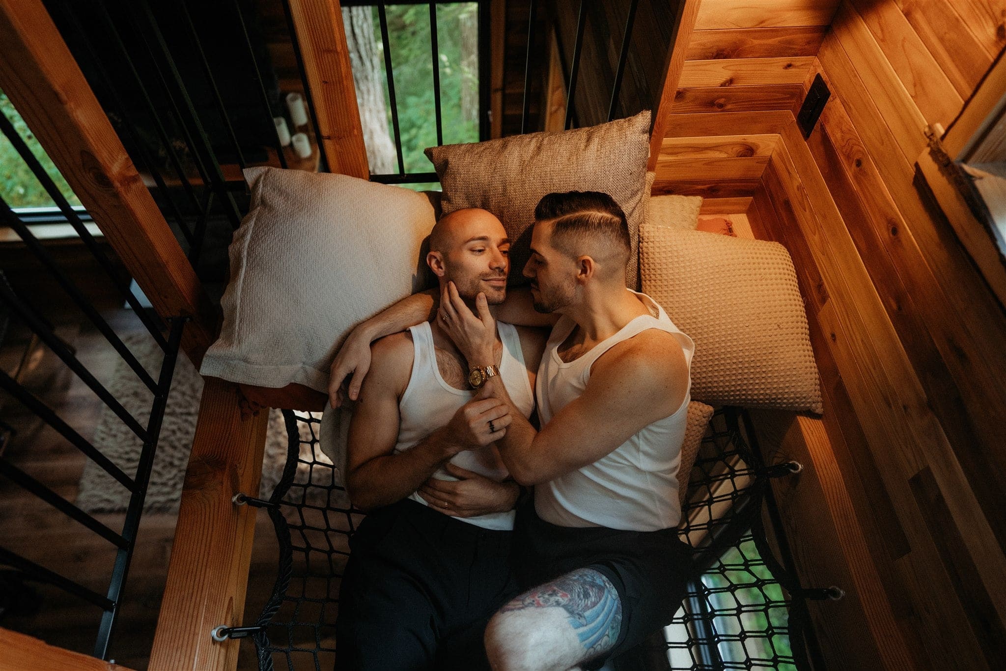 Two grooms relax in a hammock before getting ready for their elopement
