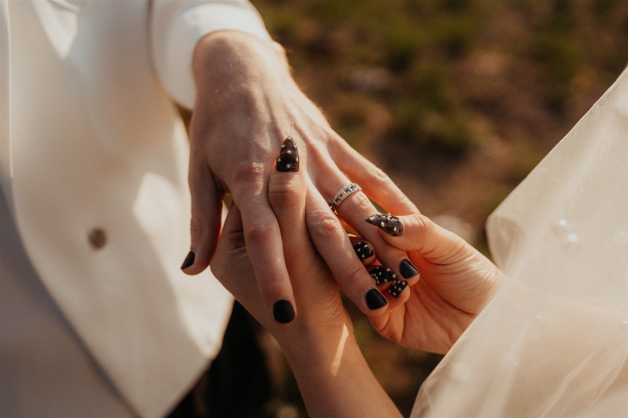 Bride puts ring on groom's finger during their elopement ceremony