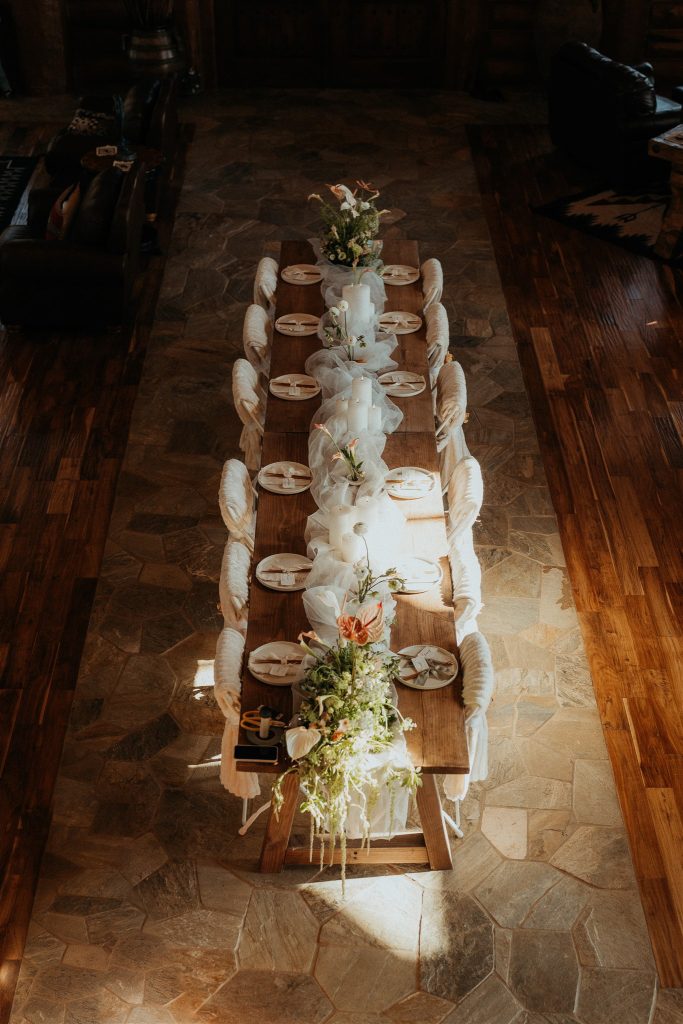 a delicately decorated dinner table flooded with natural light.