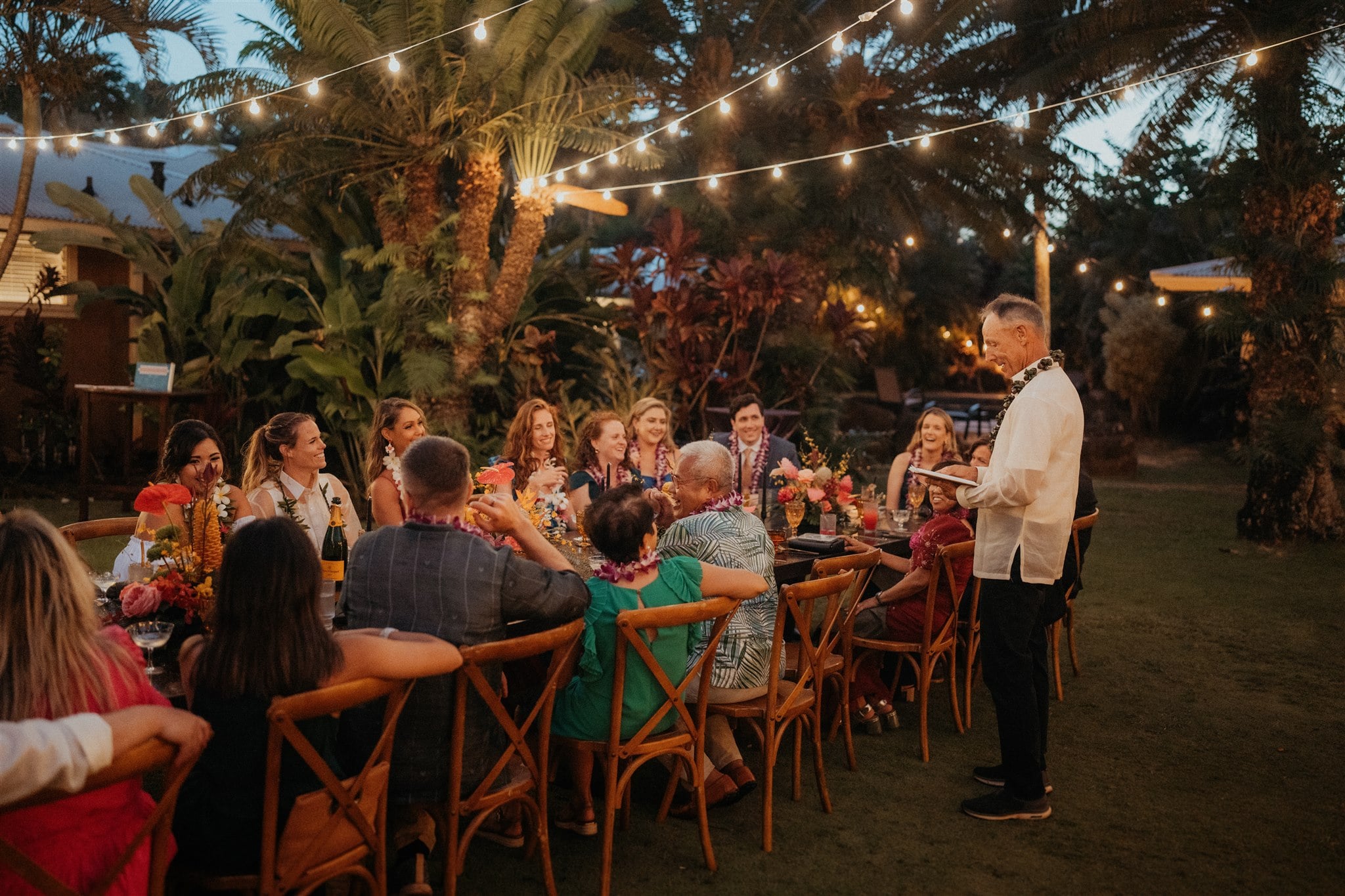 Guest gives a speech at a backyard Kauai micro wedding reception.