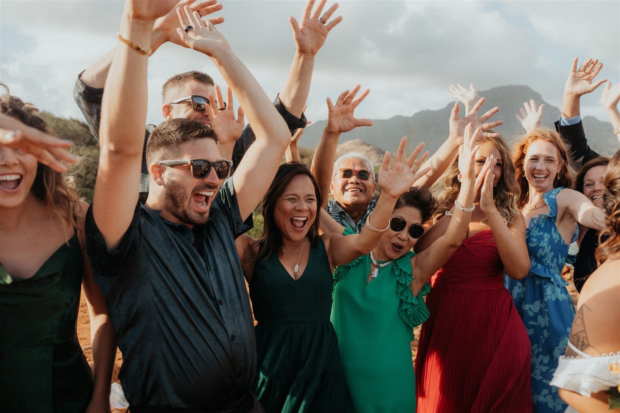 Guests cheer during Kauai micro wedding ceremony on the cliffs.