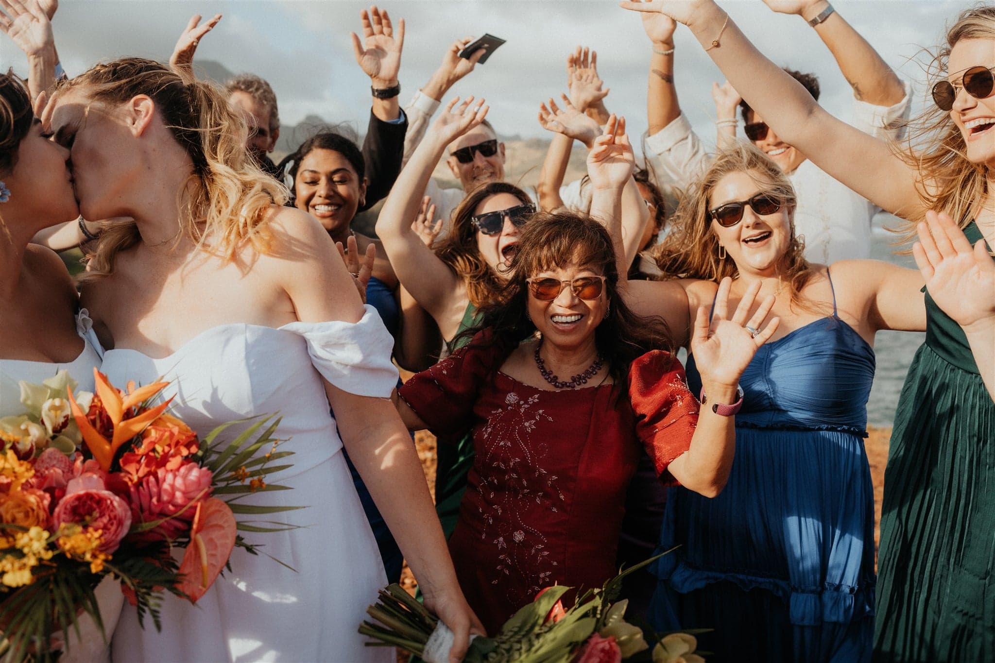 Guests cheer during Kauai micro wedding ceremony on the cliffs.