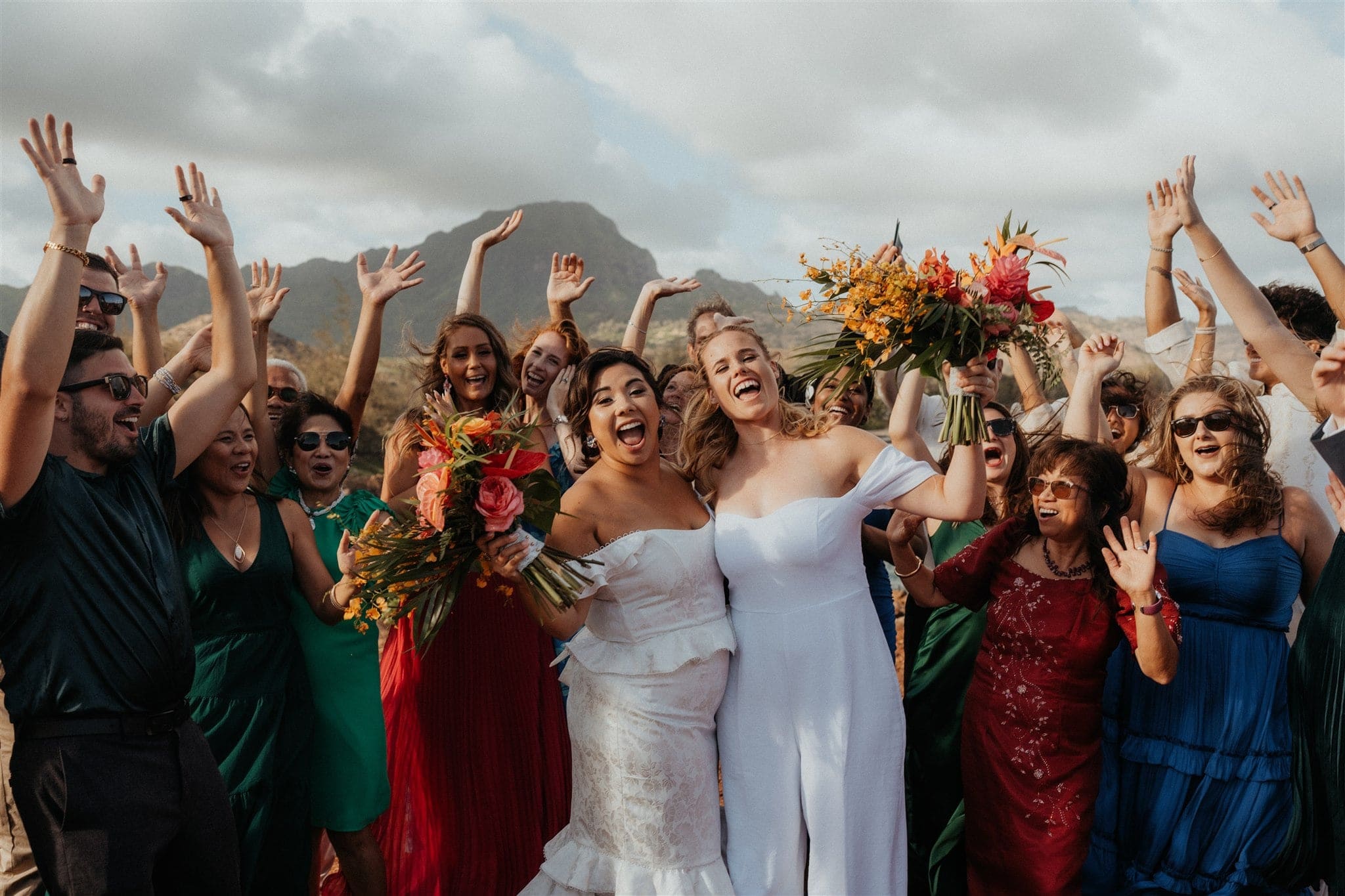 Brides and guests cheer after their micro wedding ceremony in Kauai.