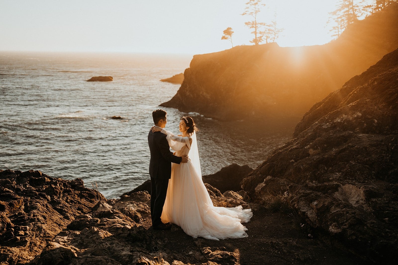 Bride and groom slow dance on the cliffs at sunset during their Oregon adventure elopement.