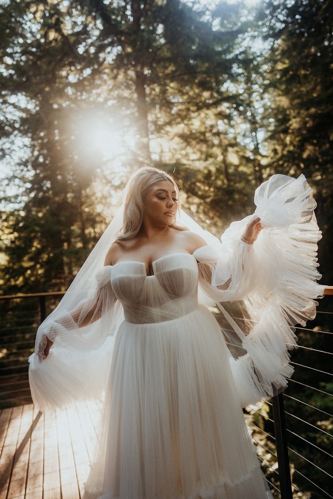 Bride plays with her dress while getting ready for her wedding weekend on the Oregon Coast.