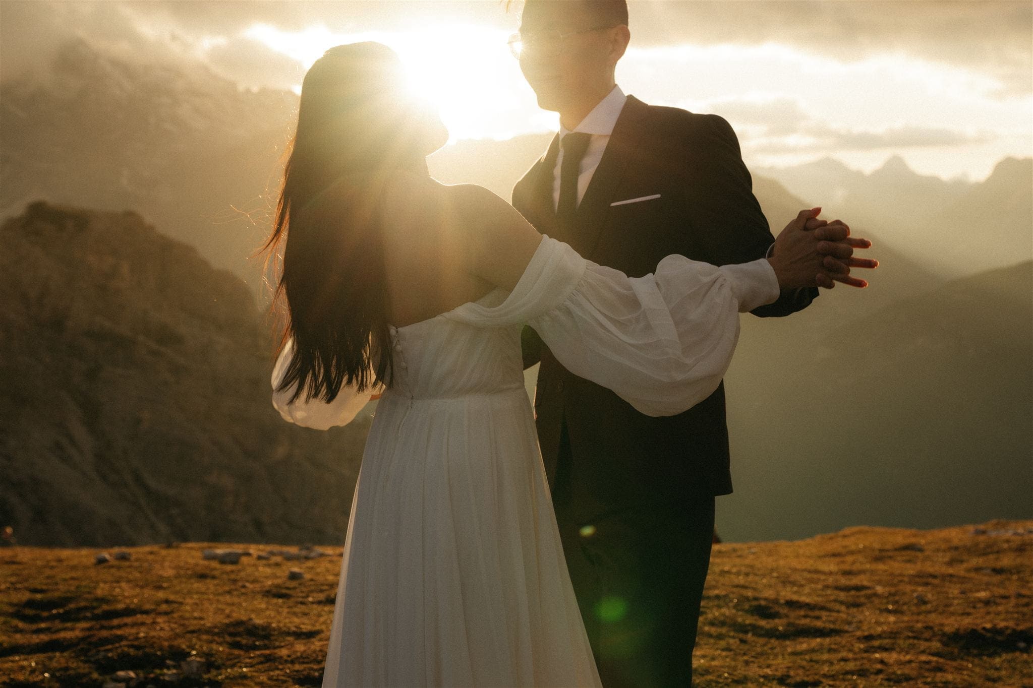 Bride and groom dance in the Dolomites during their mountain wedding photo session.