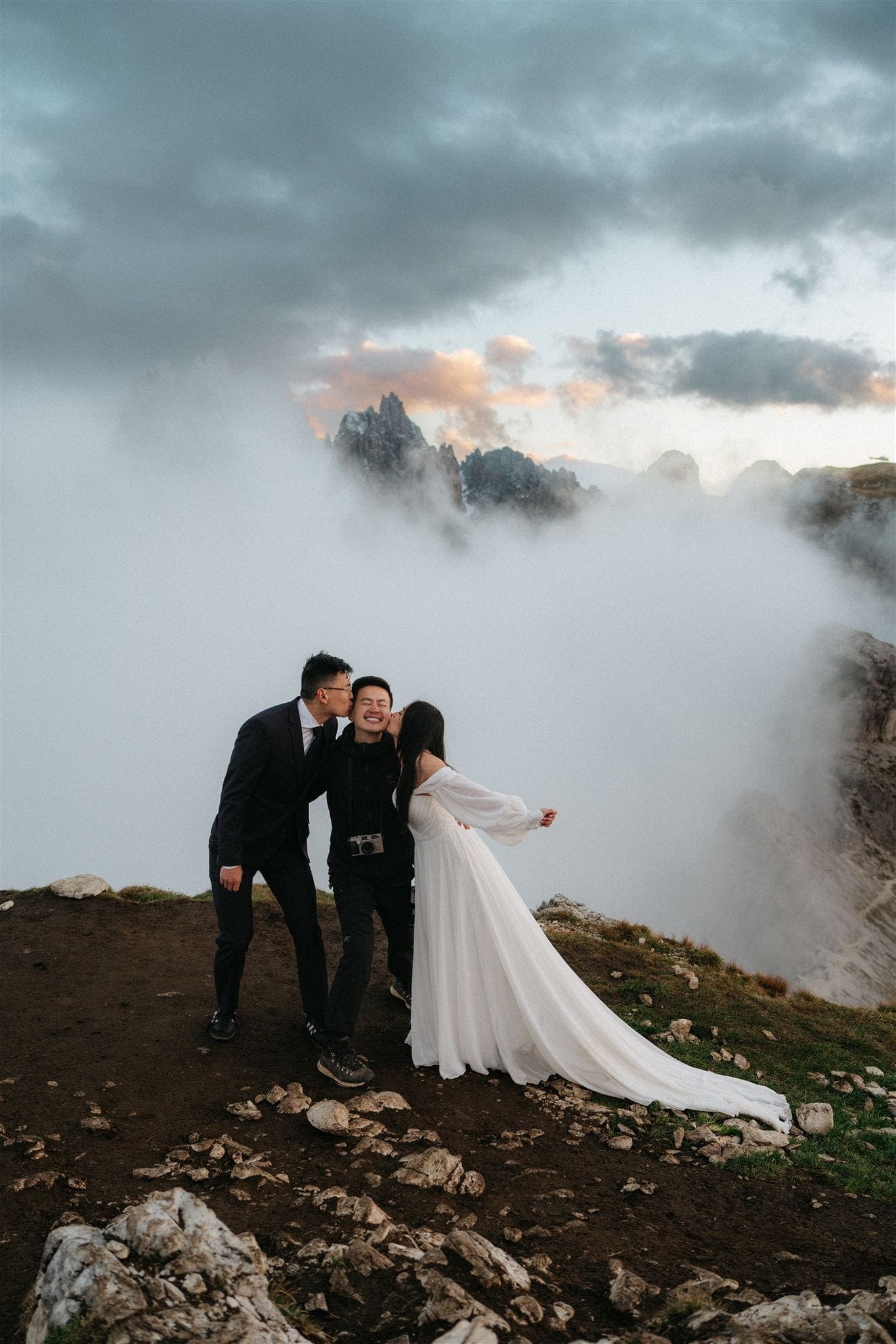 Bride and groom kiss their Dolomites wedding photographer on the cheek at the end of their two day Dolomites wedding.