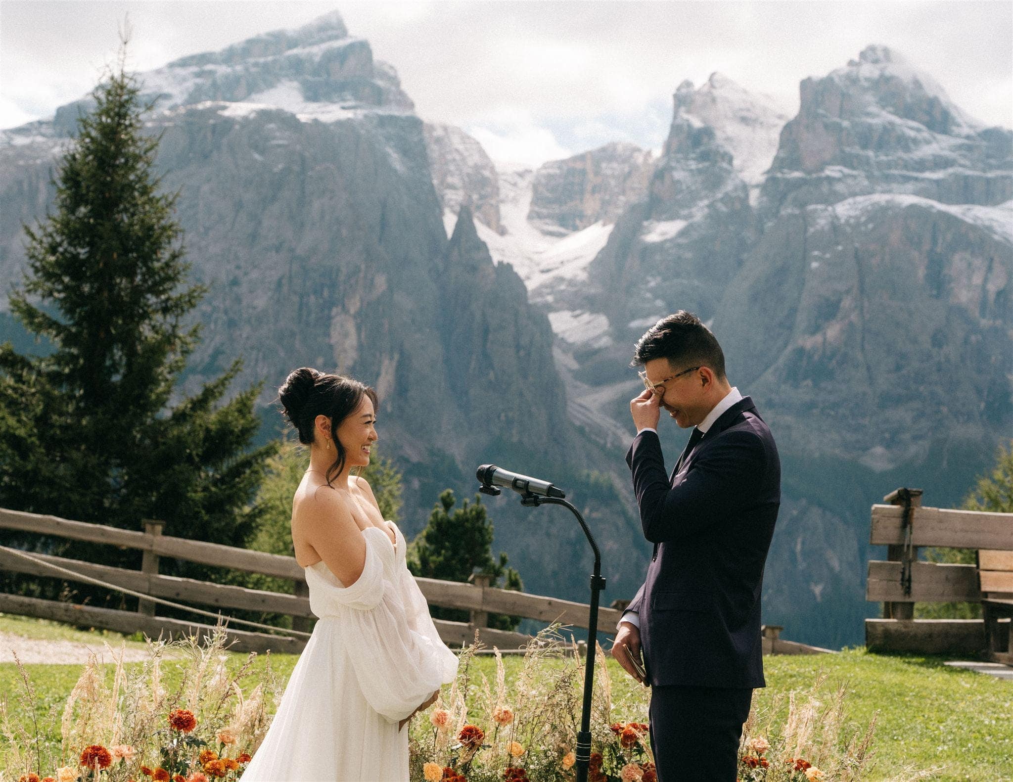 Groom wipes away his tears during his mountain wedding ceremony in the Italian Alps.