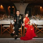 Bride and groom wear traditional Chinese wedding attire at their Dolomites wedding reception.