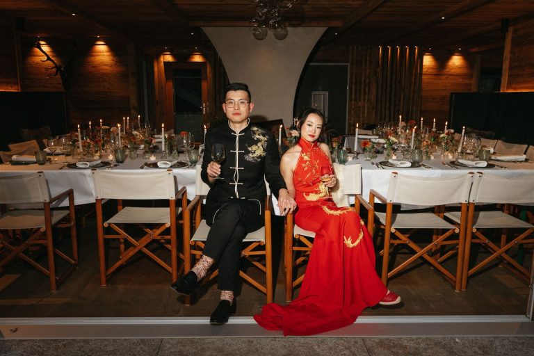 Bride and groom wear traditional Chinese wedding attire at their Dolomites wedding reception.