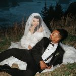 Bride and groom sit on the ground near the Oregon Coast for editorial portraits during blue hour.