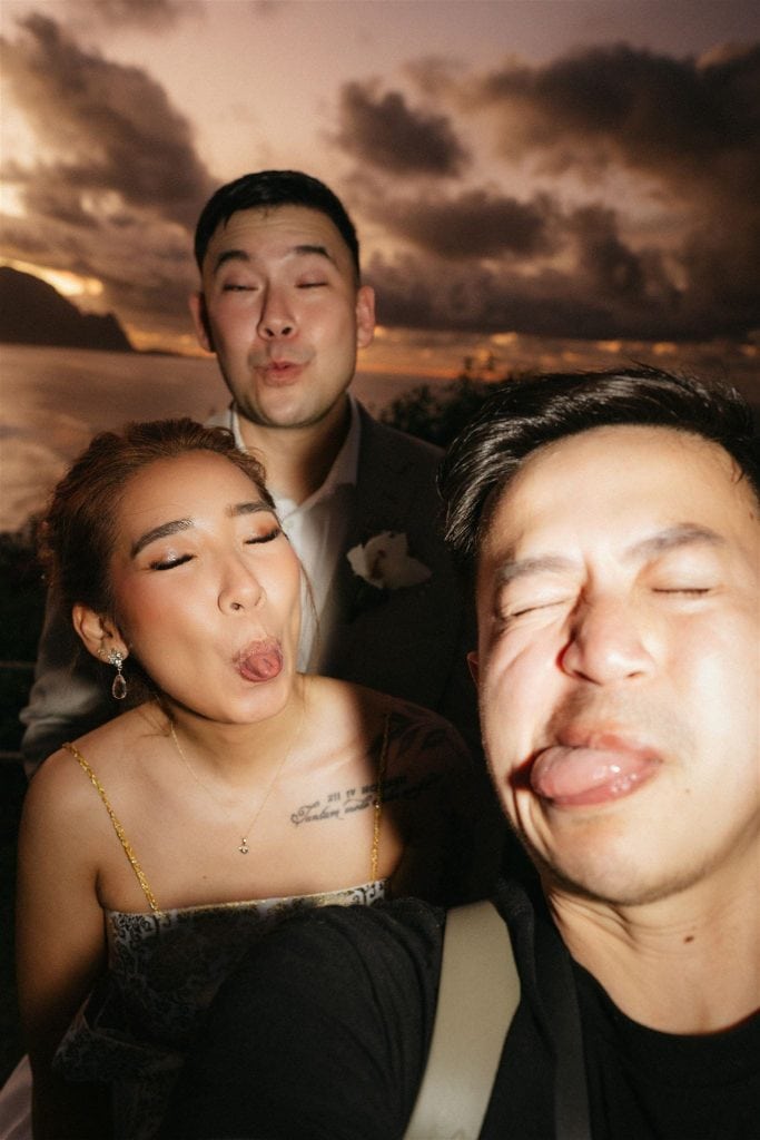 Kauai elopement photographer and newlyweds take a candid selfie after sunset.