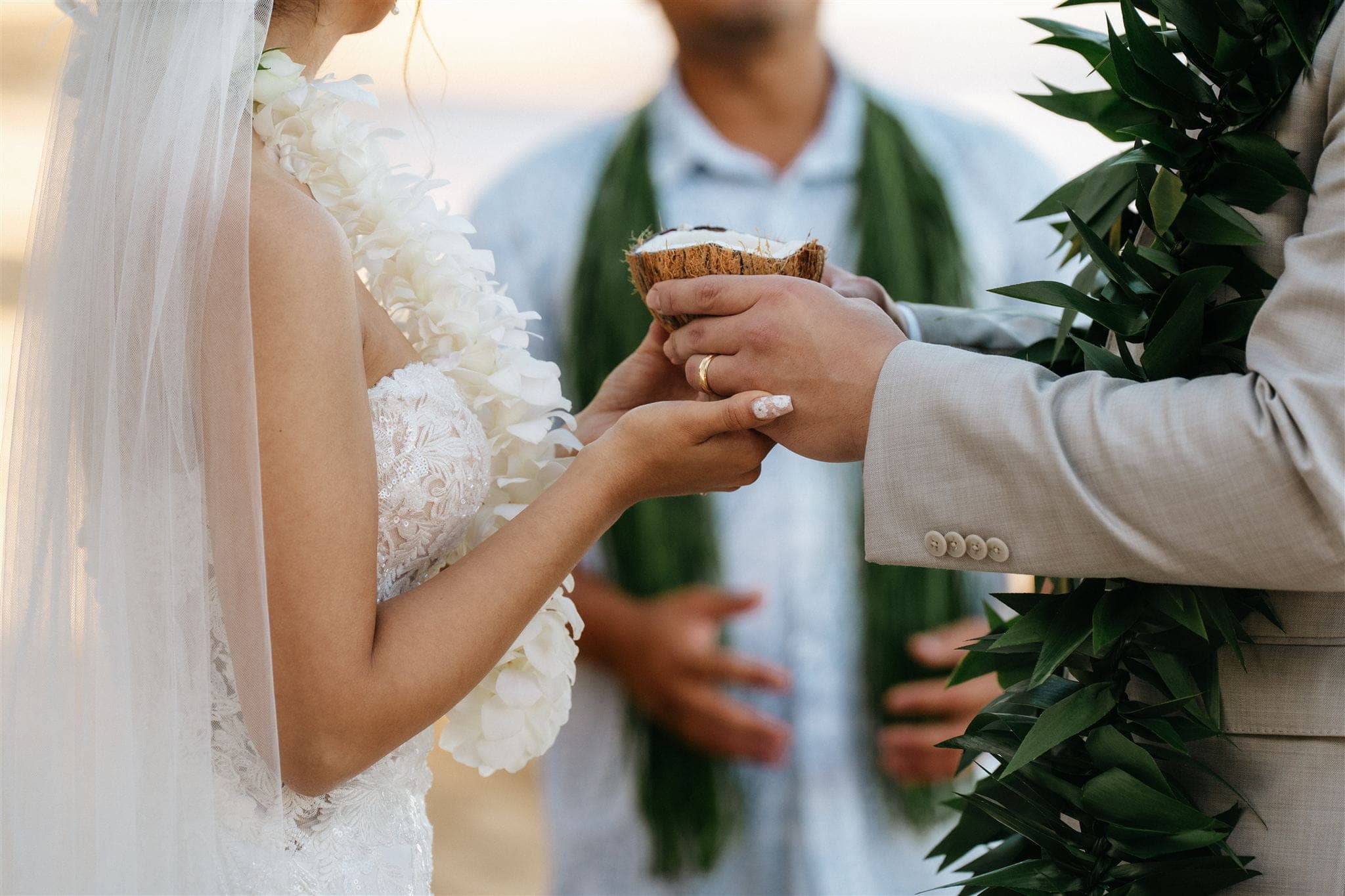 Bride and groom hold a coconut during their Kauai elopement ceremony.