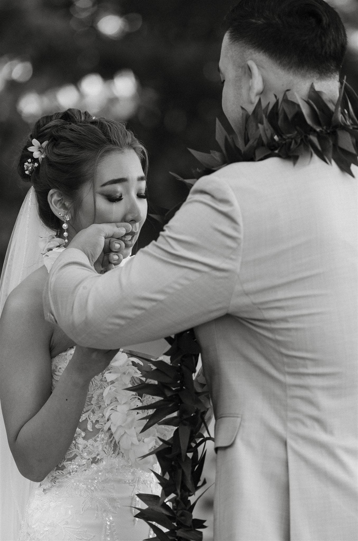 bride crying while groom wiping her tears at their ceremony captured by henry tieu photography - washington state and destination wedding photographer