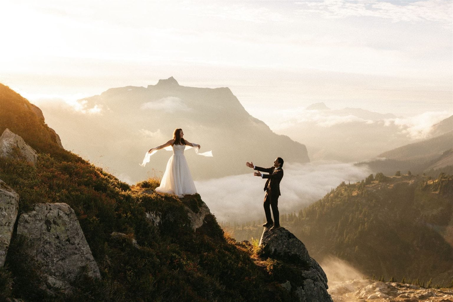 Couple stands on the edge of a mountain during their sunset Mt Baker elopement portraits.