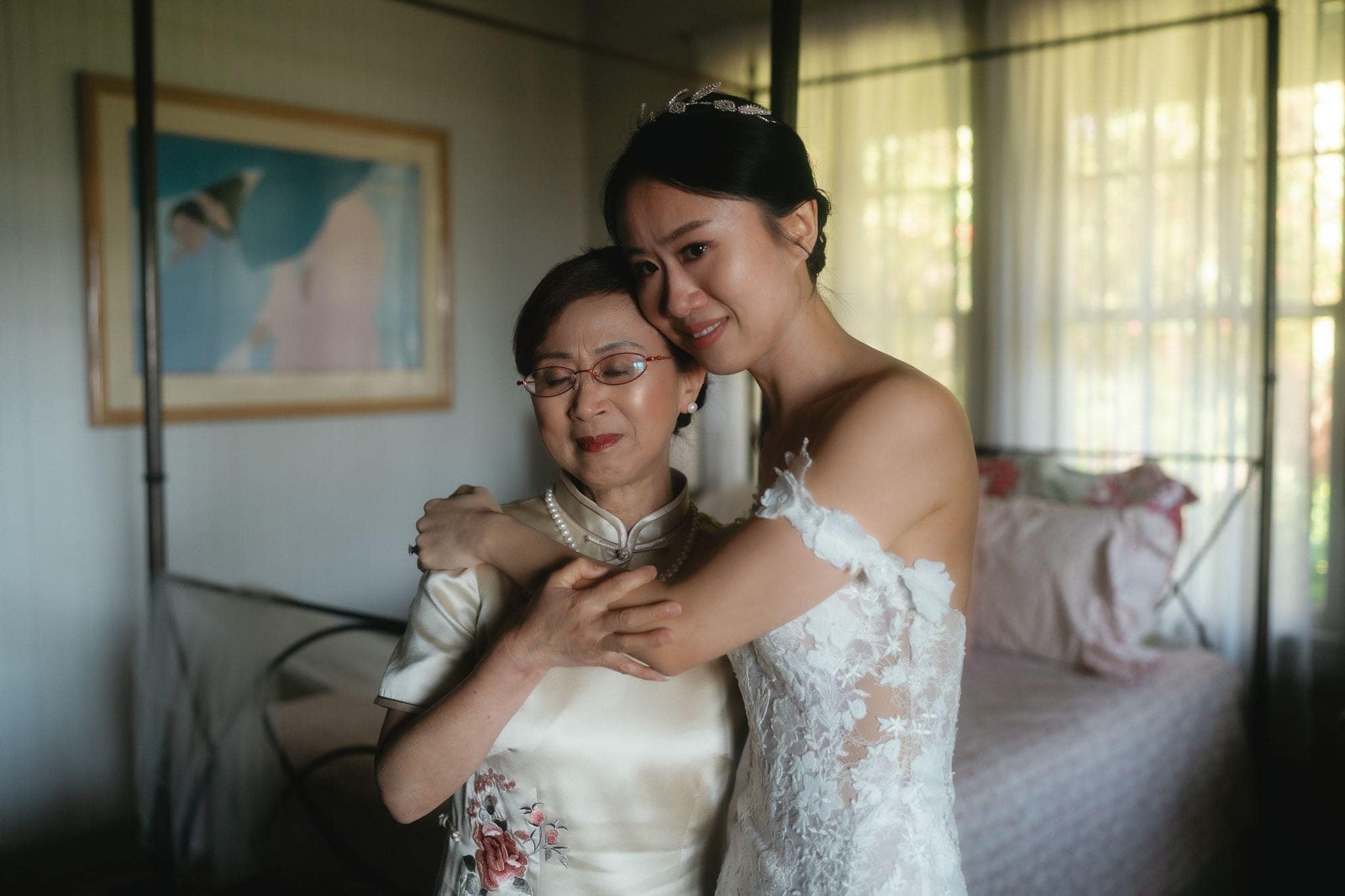 Bride and mother hug and get emotional while getting ready for a Maui micro wedding at Olowalu Plantation House.