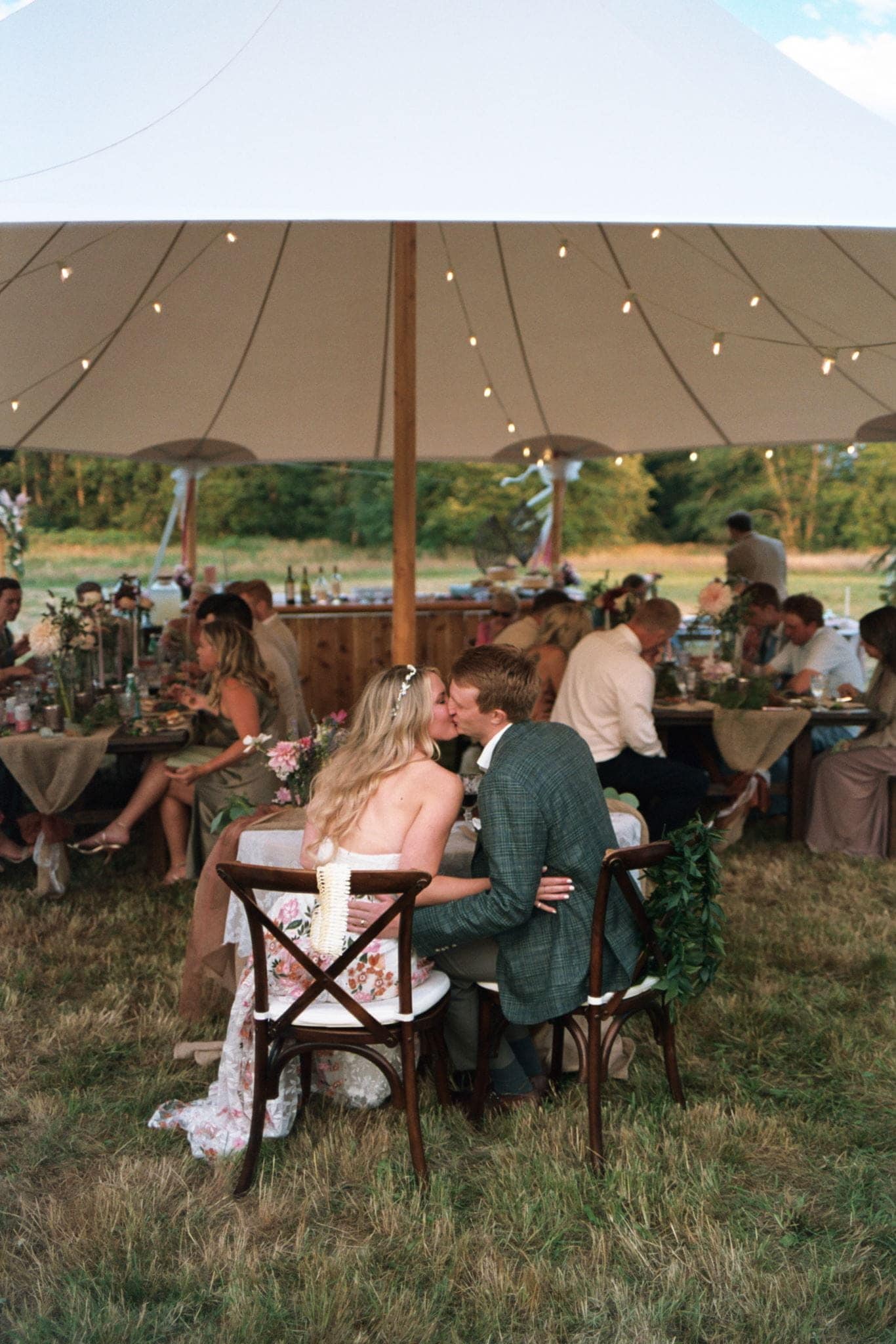 Film portrait of bride and groom kissing at their Washington micro wedding reception.