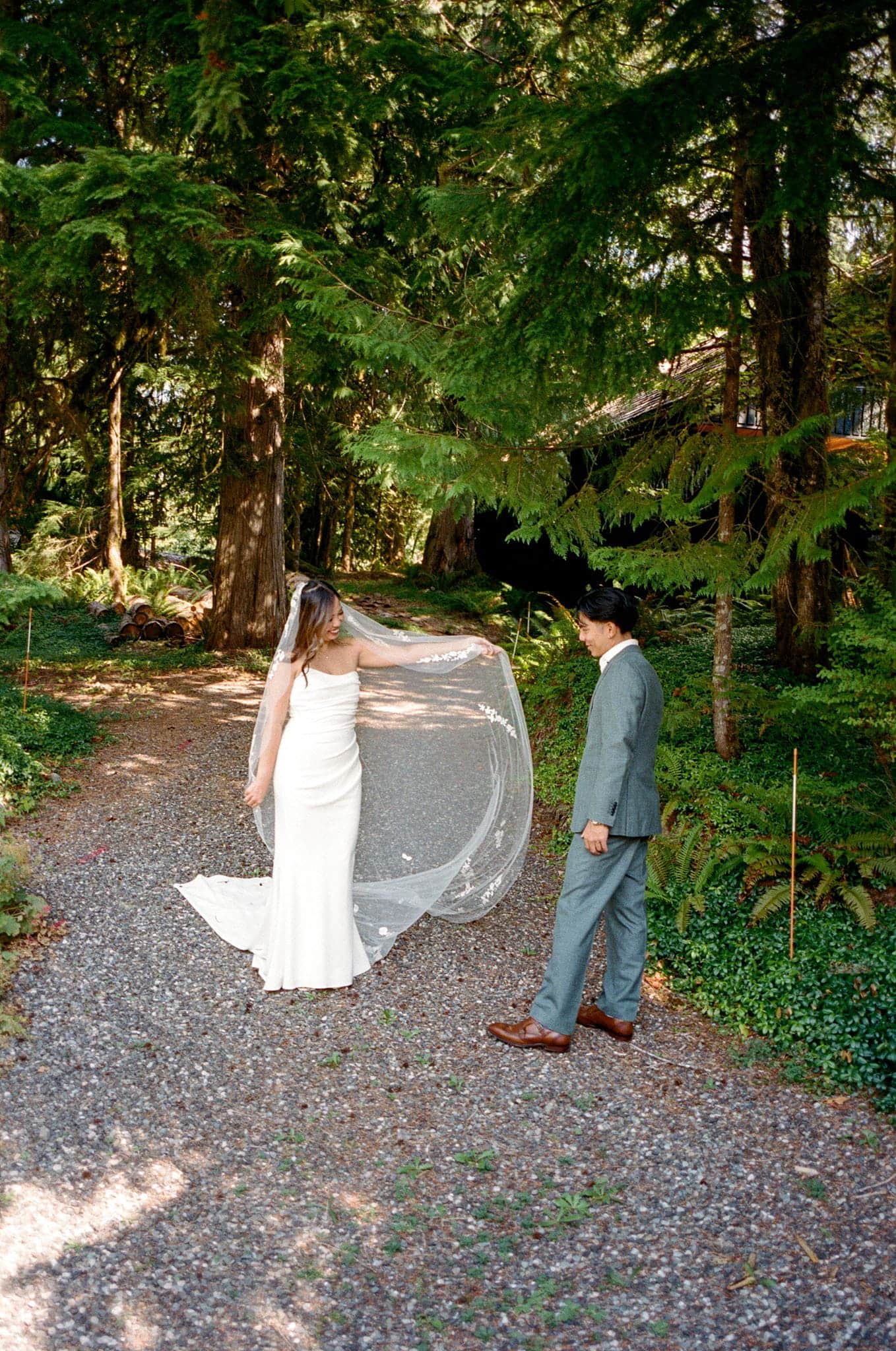 Newlyweds do a private first look in the forest during their Washington film wedding photo session.