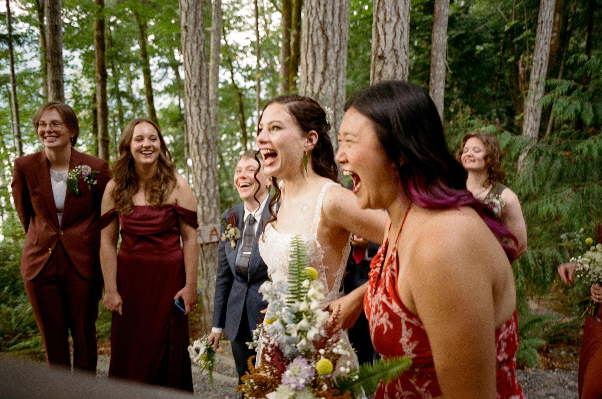 Guests react to seeing the bride during an Olympic National Forest wedding.