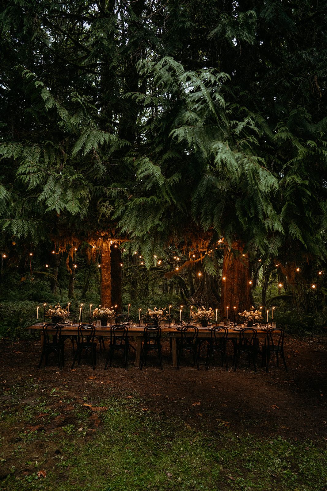 Candlelit forest wedding reception at Baker Haus Lodge, a micro wedding venue in Washington.