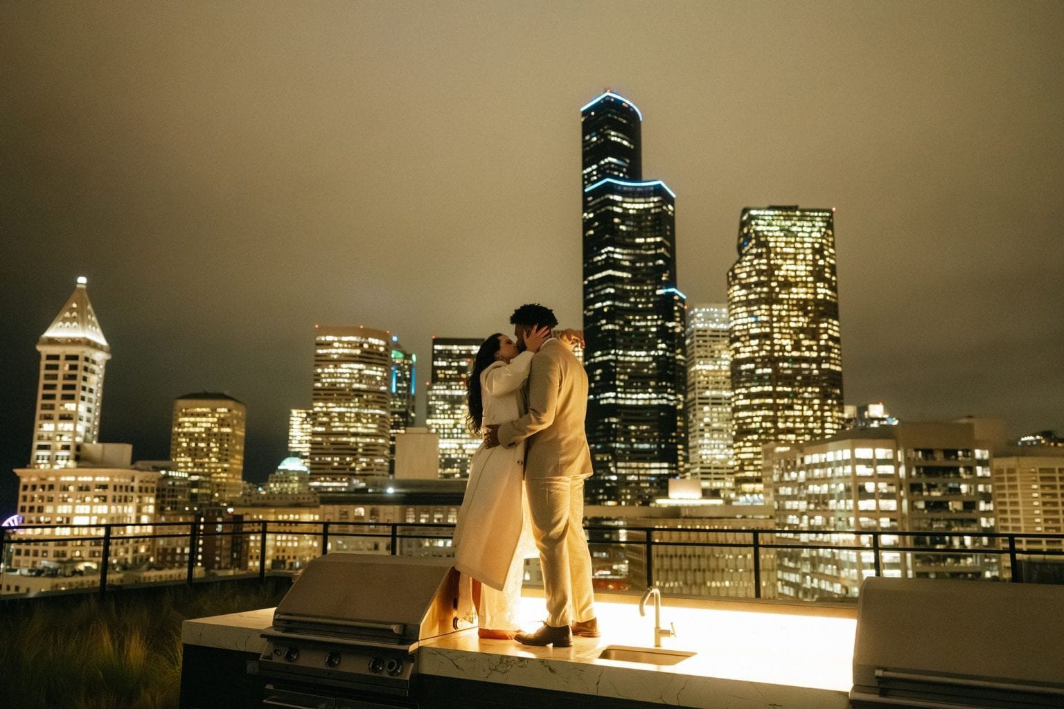 Couple kisses on a rooftop after their Seattle courthouse elopement.