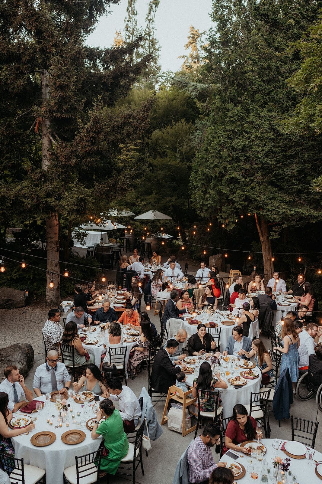 Guests sit at reception tables at JM Cellars, a winery micro wedding venue in Washington.