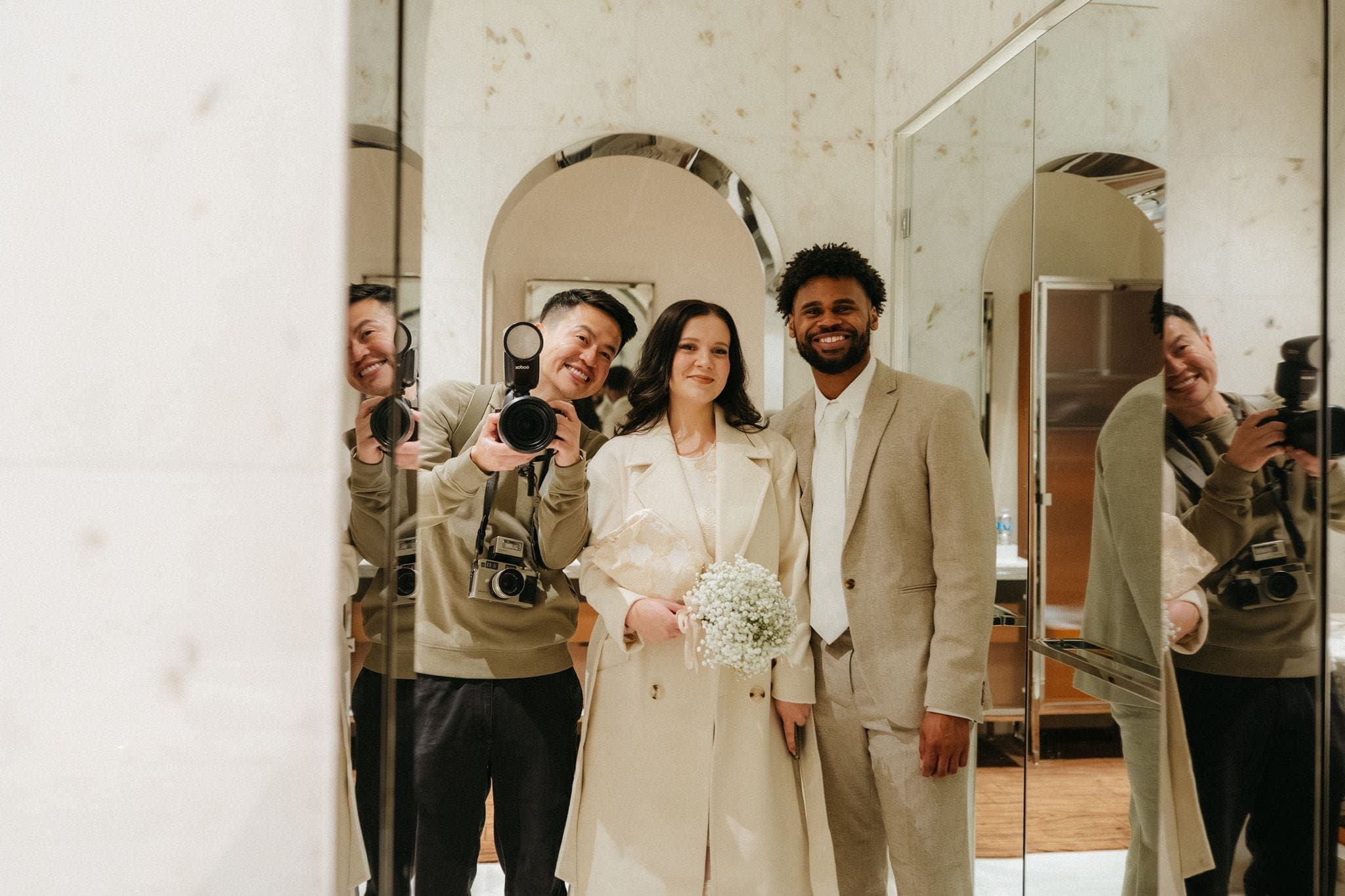 Seattle courthouse wedding photographer poses with couple in front of a mirror at their hotel.